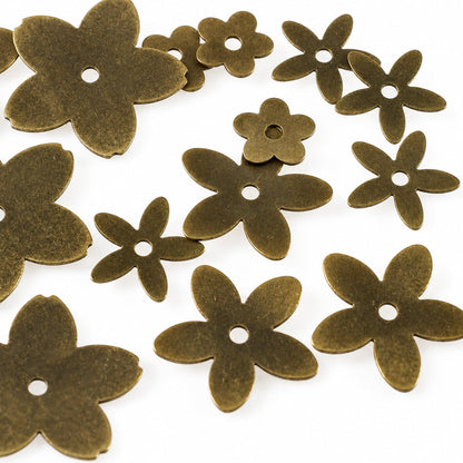 Dark brown flower-shaped craft beads with five petals and a central hole, scattered on a plain white background.