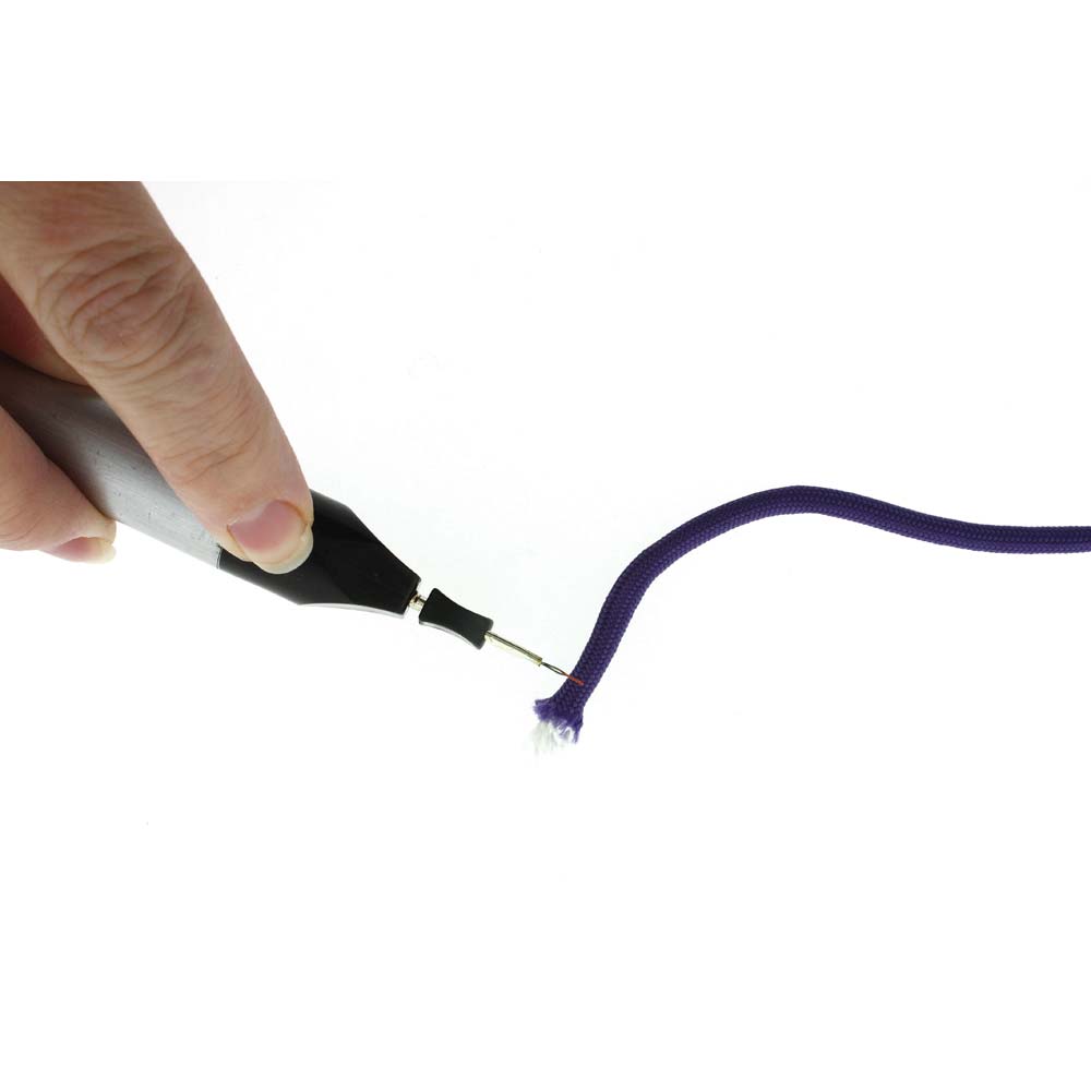 A close-up of a hand holding a black and silver pen-like tool with a fine metal tip touching the end of a purple cord, against a plain white background.