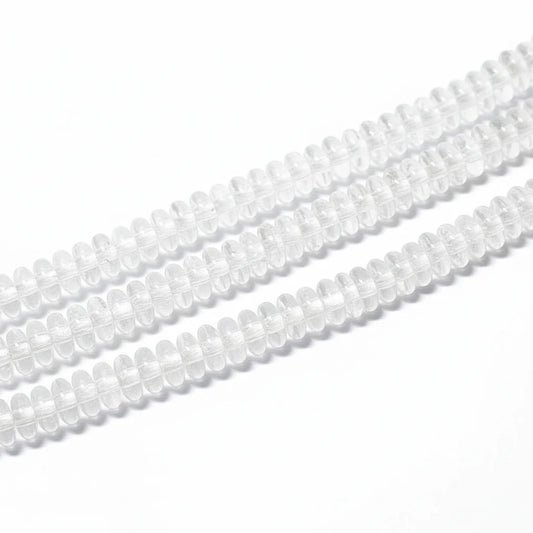 Clear glass or acrylic oval beads strung in multiple rows on a white background.