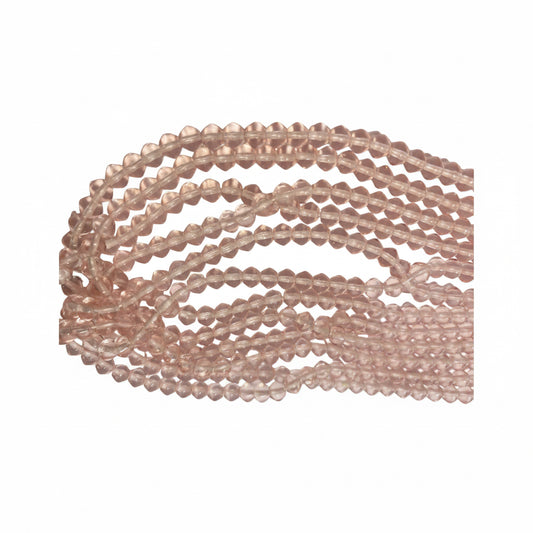 Multiple strands of faceted rose quartz beads in a light pinkish-tan hue, arranged in curved loops on a plain light background.