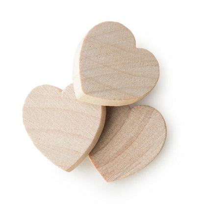 Three unfinished light wood heart-shaped blocks with visible grain, arranged on a plain white background.