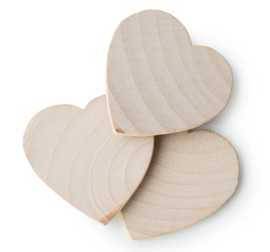 Three unfinished light wood heart-shaped cutouts with visible grain, arranged overlapping on a white background.