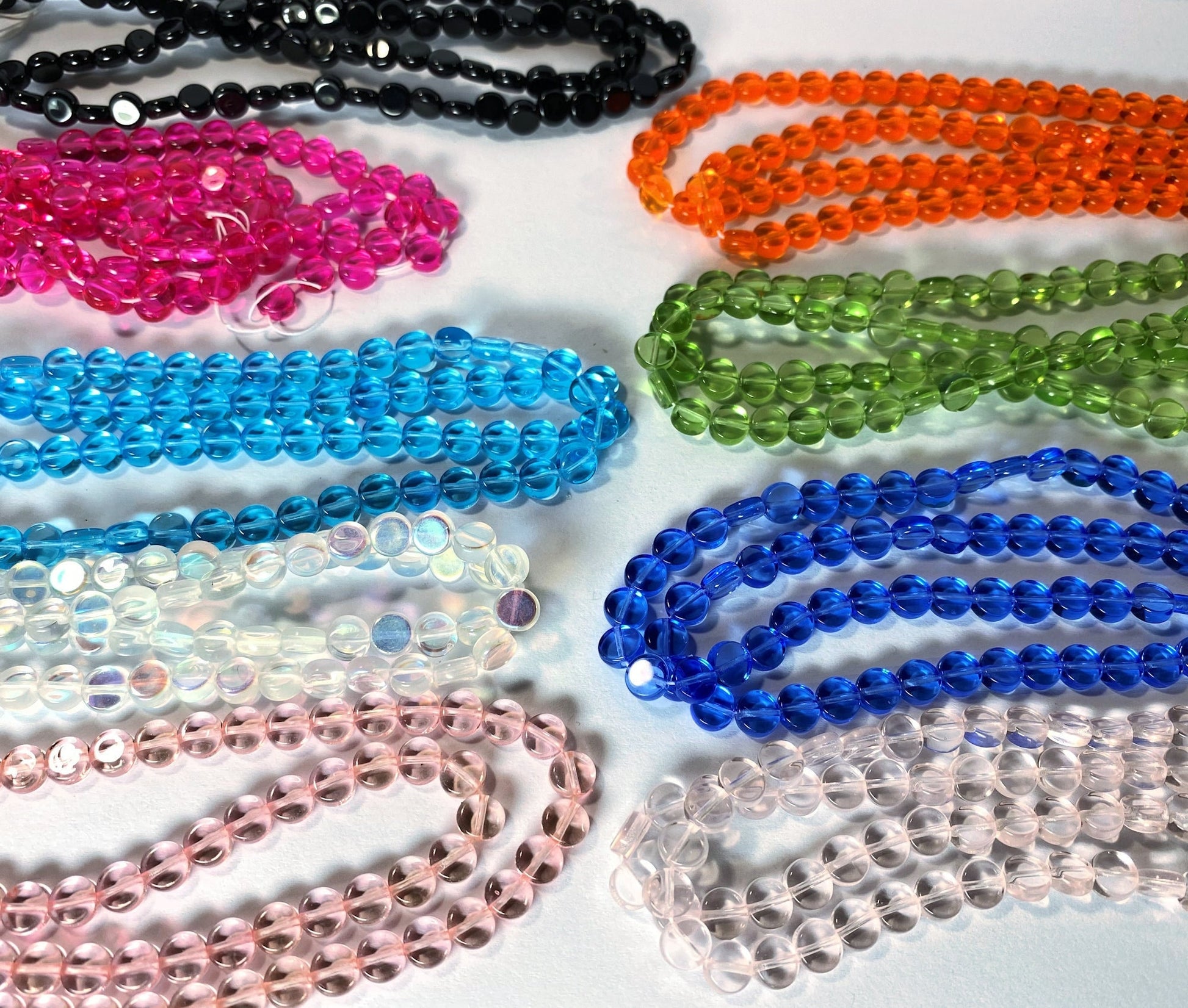 Colorful beads arranged in a grid on a white background