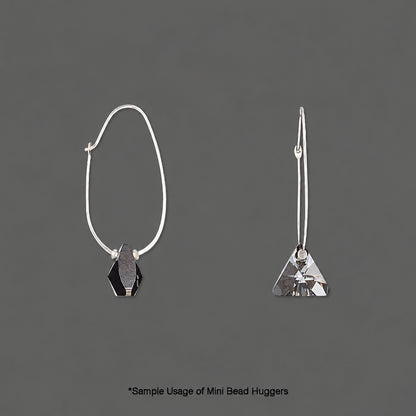 Two silver-tone mini bead huggers shown on a dark gray background, one as a front view with a faceted black hexagonal bead and the other as a side view with a faceted silver triangular bead. Text at the bottom reads '*Sample Usage of Mini Bead Huggers'.