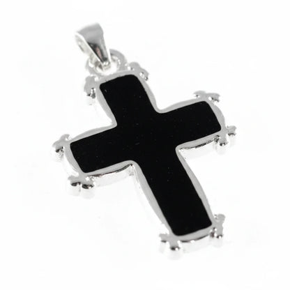 A sterling silver cross pendant with a glossy black enamel center, shown on a plain light background.
