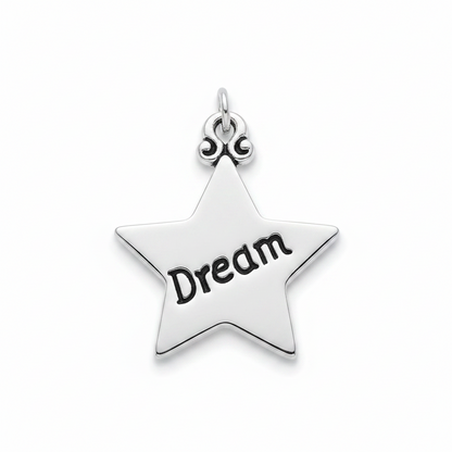 A silver star-shaped pendant charm with the word 'Dream' engraved in black on its center, shown on a clean white background.