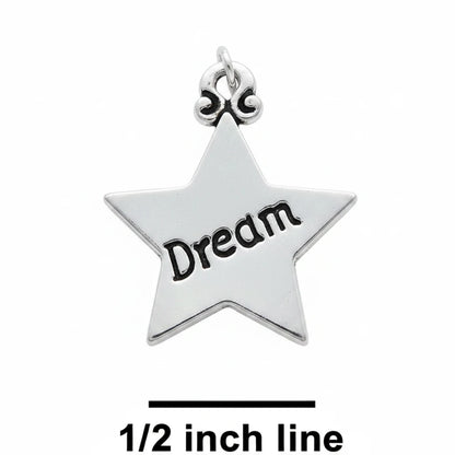 A silver star-shaped charm engraved with the word 'Dream' in black, shown on a textured blue background with a size reference label '1/2 inch line' below.