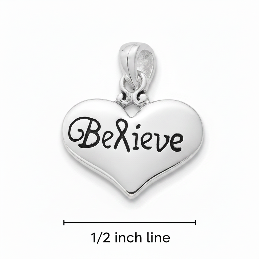 A silver heart-shaped pendant charm engraved with the word 'Believe' in black script, shown on a white background with a dimension line indicating 1/2 inch line.