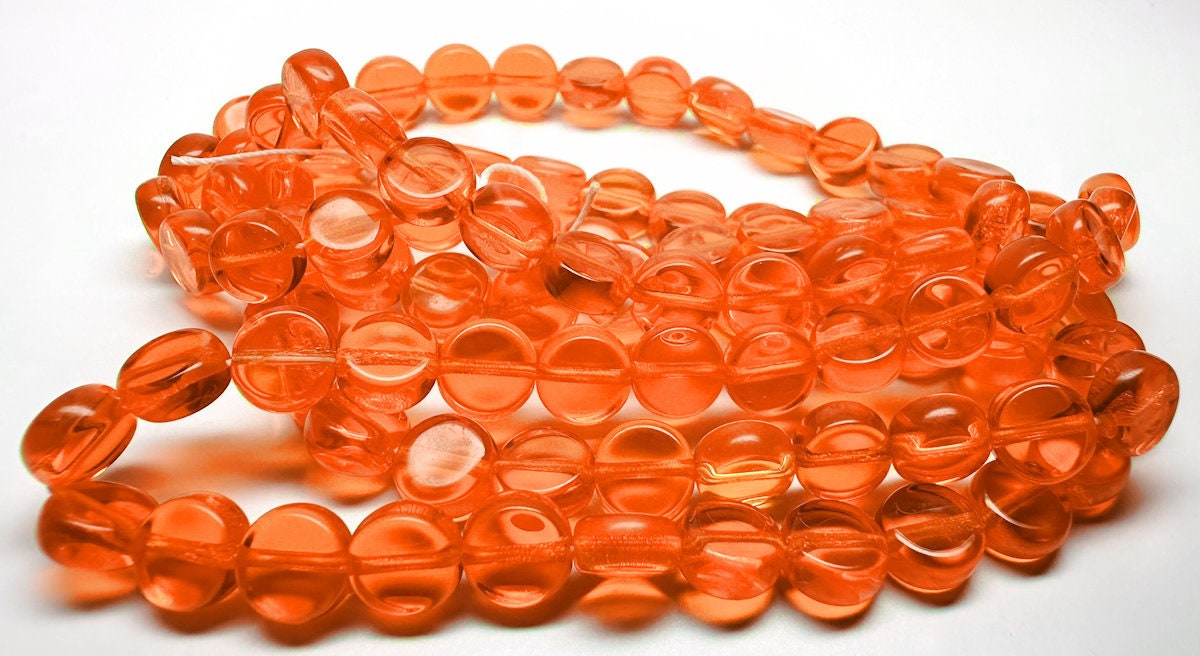 Orange glass beads on a white background