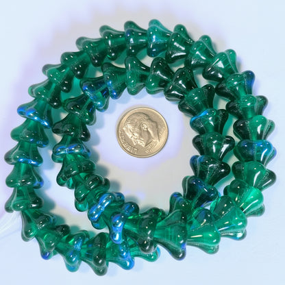 A coiled strand of translucent green and blue glass beads, shown with a US quarter coin for scale on a white background.