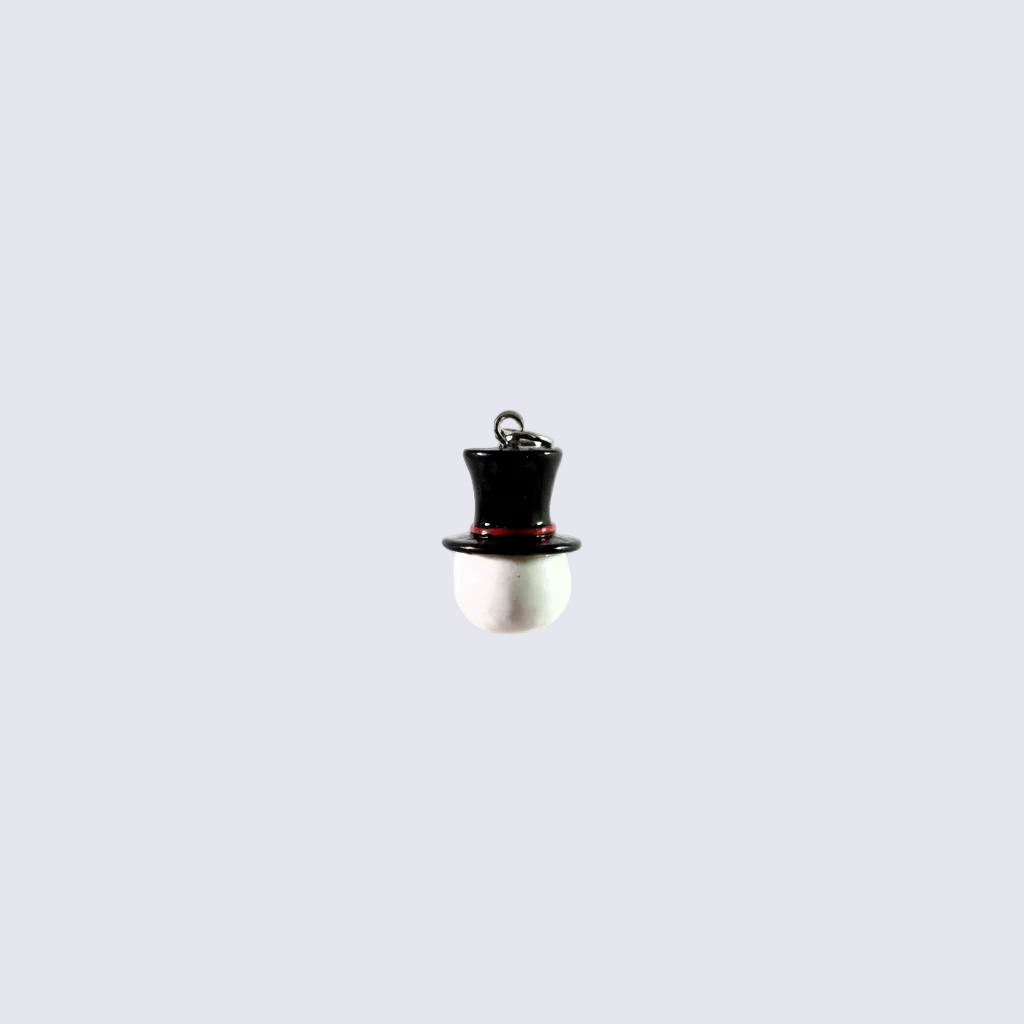 A miniature black top hat charm with a silver metal loop at the crown, featuring a thin red accent line around the brim, set against a solid white background.
