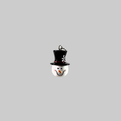 A small snowman ornament or charm with a glossy black top hat, white face and hat base, pink cheeks, an orange carrot nose, and a silver hanging loop at the top, shown on a plain white background.