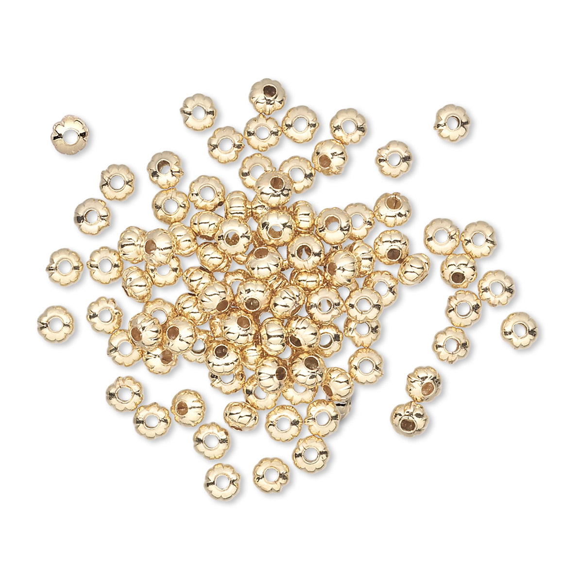 Gold beads scattered on a white background