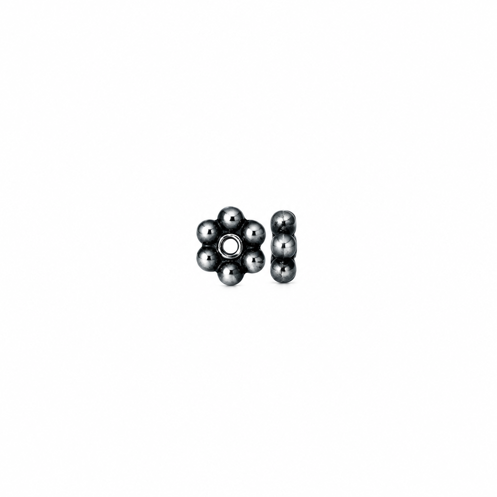 A small cluster of dark metallic beads, including a flower-shaped piece with six beads and a vertical strand of five beads, shown on a plain white background.