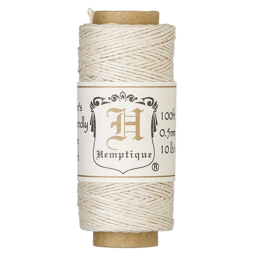 A spool of cream-colored cotton twine with a brown cardboard core and a white paper label featuring the Hemptique brand logo.