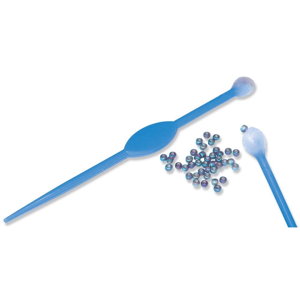 Blue plastic scoop with small beads on a white background