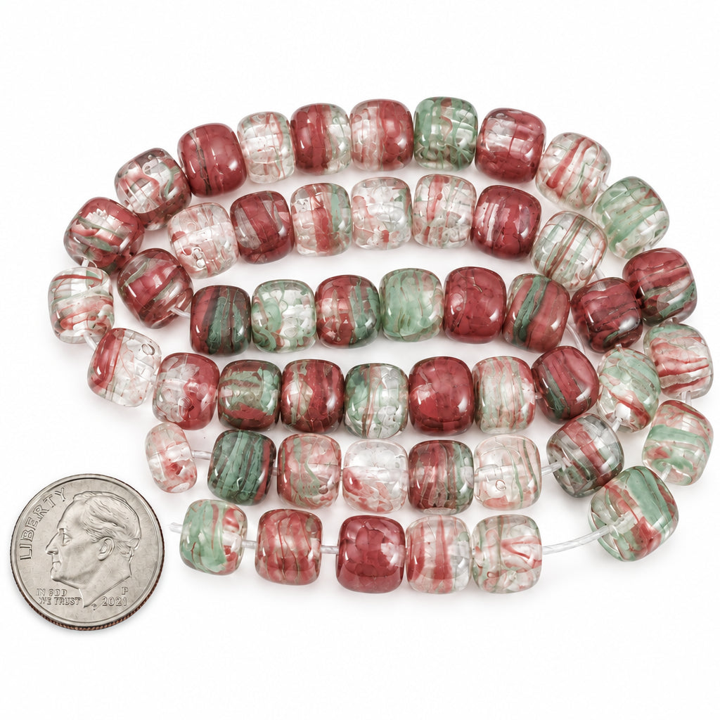 A coiled strand of red and green marbled glass beads with a US quarter coin for scale, on a white background with 'The Mystical Garden Path' text overlay.
