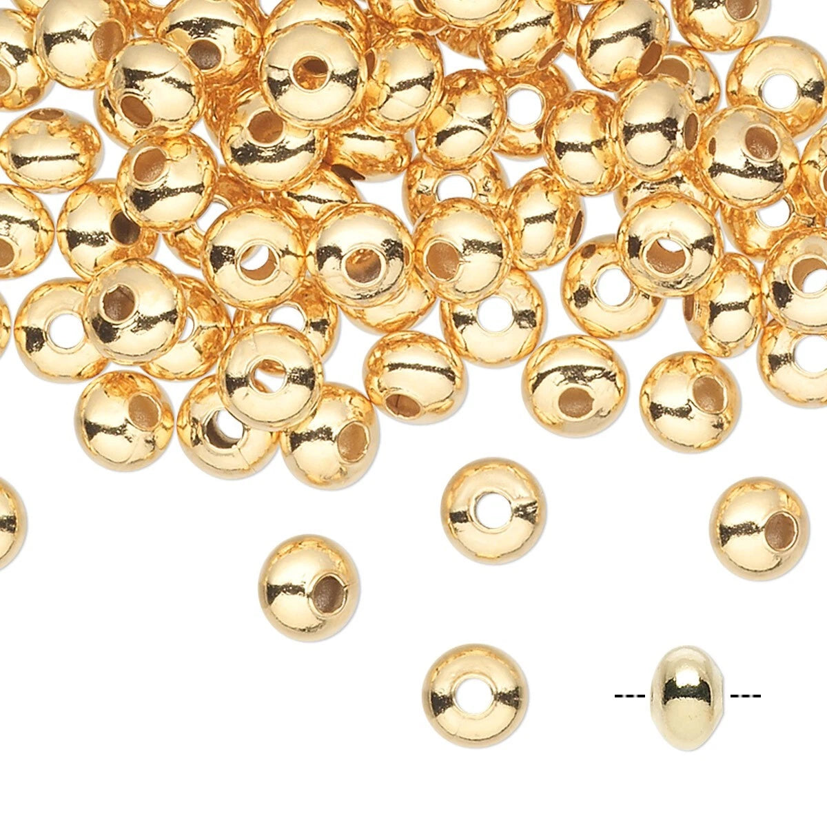 Gold metallic round spacer beads with a central hole, scattered on a white background with a few individual beads and a dashed line indicating size.