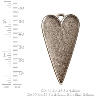 A heart-shaped silver metal pendant with a textured finish and a top loop, shown next to a ruler for scale with dimensions printed below.
