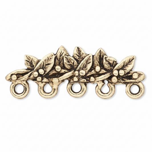 An antique gold-toned metal holly branch charm with five hanging loops, shown on a plain white background.