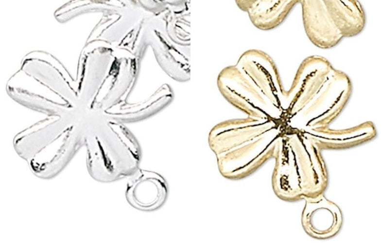 Two metallic flower-shaped charms with looped bottoms, shown side by side in silver and gold finishes on a plain white background.