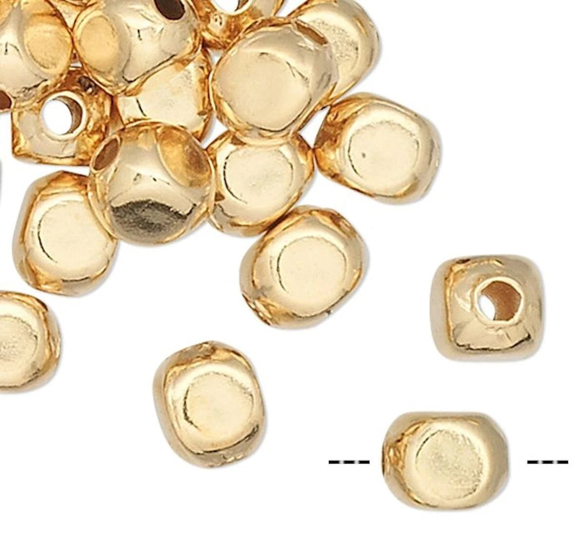 Gold beads on a white background