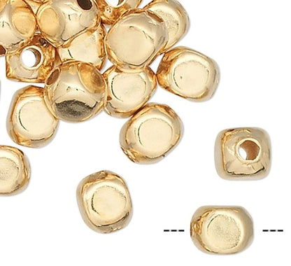 Gold beads on a white background