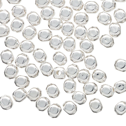 Close-up of silver beads on a white background
