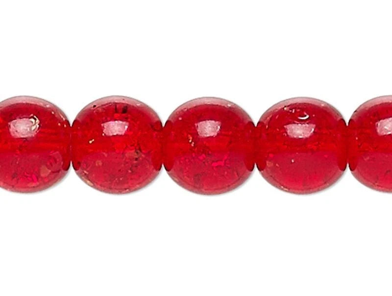 Close-up of red glass beads on a white background