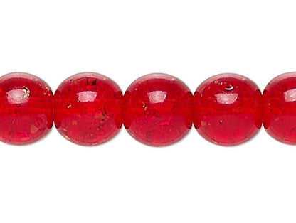 Close-up of red glass beads on a white background