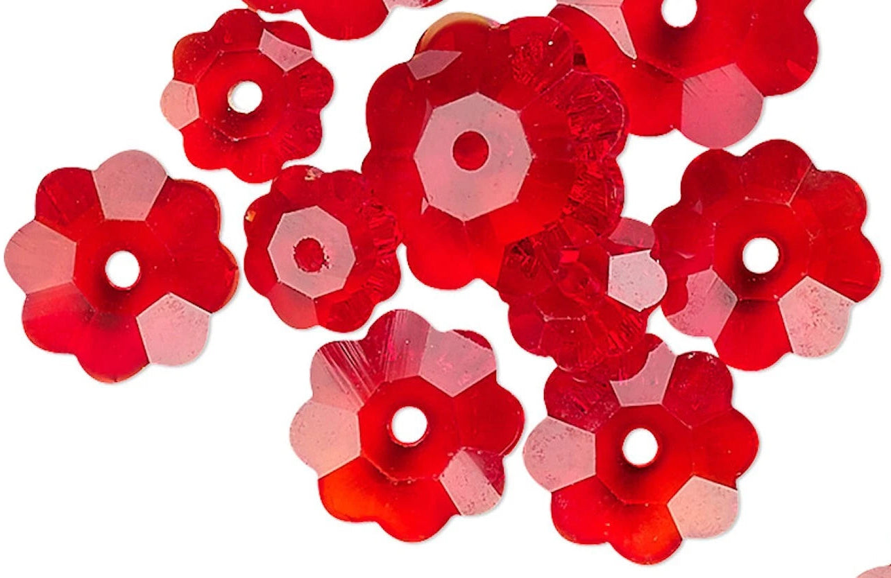 Red flower-shaped beads on a white background