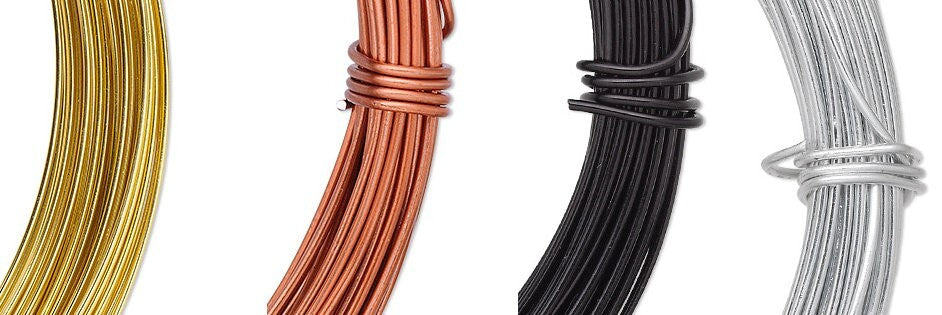 Three spools of wire in gold, bronze, and silver on a white background