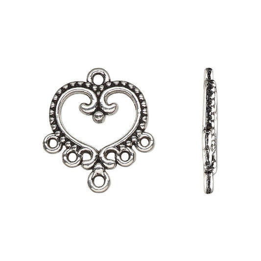 An antique silver heart-shaped decorative clasp shown from two angles: a front view displaying its ornate scrollwork and a side profile view showing the internal latch mechanism, set against a plain white background.