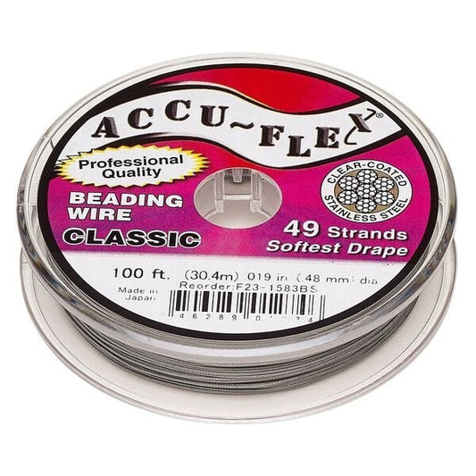 Spool of Accu-Flex beading wire with pink label on a white background