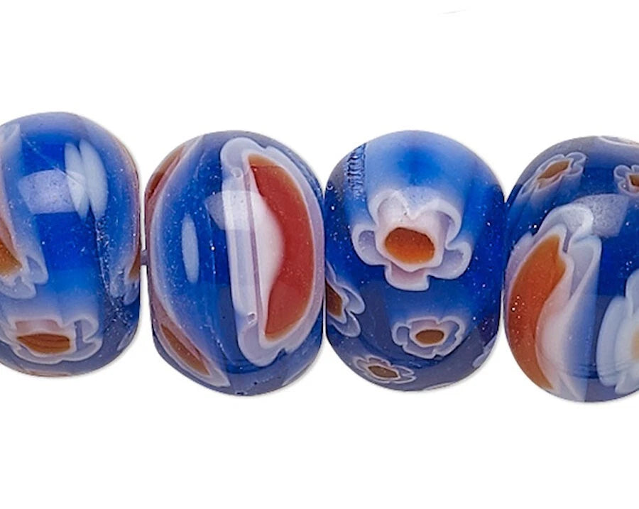 Set of blue glass beads with floral patterns on a white background