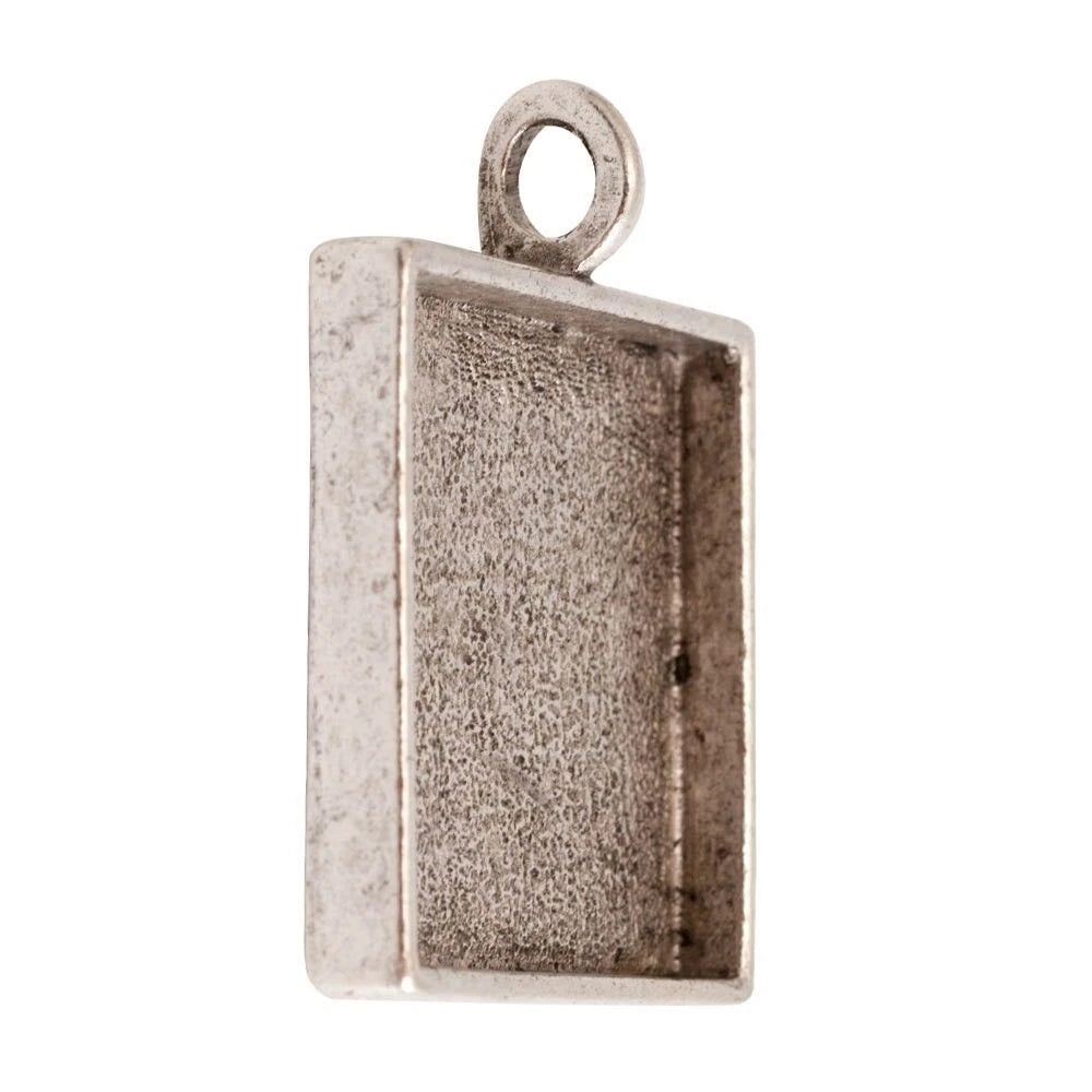 A rectangular silver-toned metal pendant or charm blank with a textured interior and a loop at the top, shown on a plain white background.
