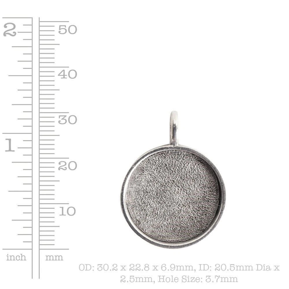A silver round cabochon pendant with a textured, oxidized finish and a top loop, shown next to a ruler scale on a white background with size text.