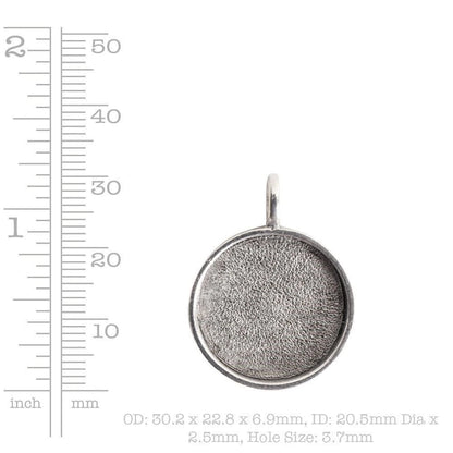 A silver round cabochon pendant with a textured, oxidized finish and a top loop, shown next to a ruler scale on a white background with size text.