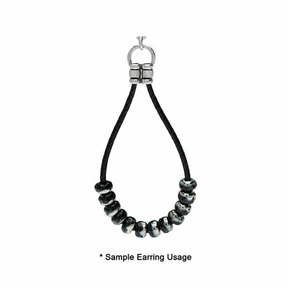 A close-up of a black cord earring with a silver metal ring clasp and a row of glossy black beads with subtle iridescent highlights, shown on a white background with the text '* Sample Earring Usage' at the bottom.