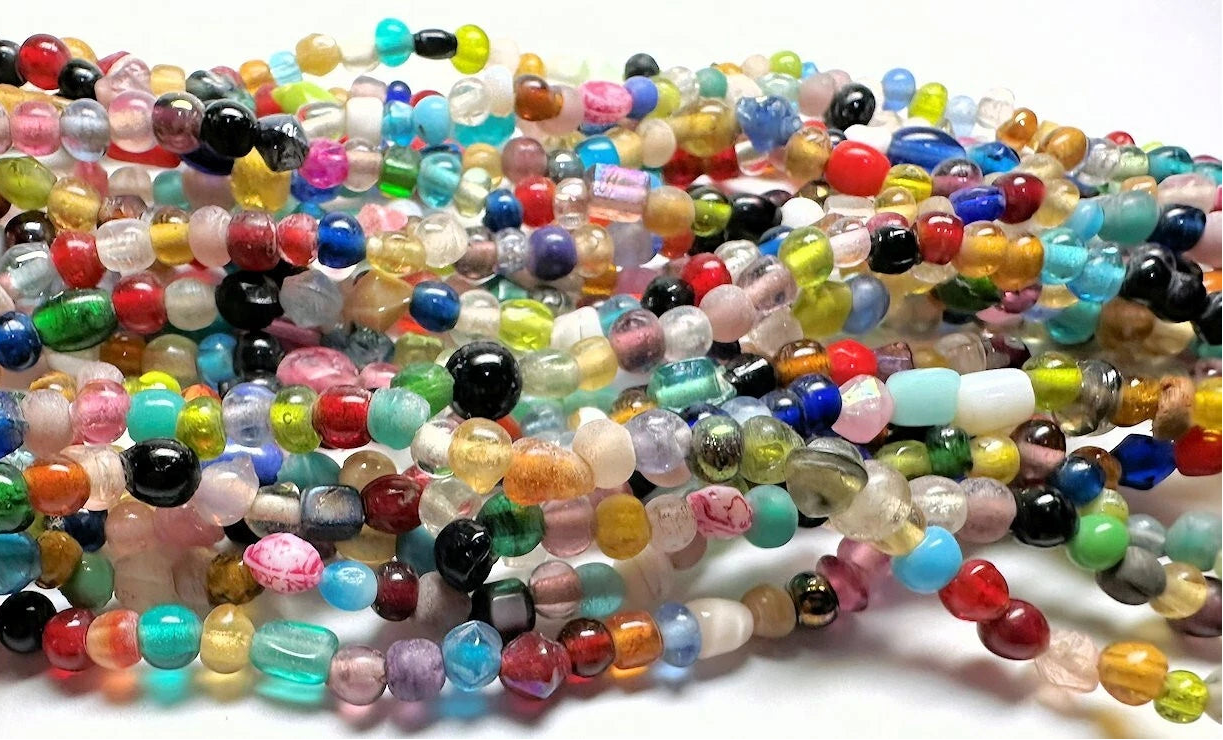 Multicolored beads on a white surface
