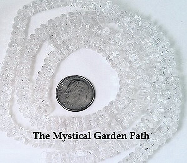 Clear faceted glass beads wound into loops on a white background, with a silver coin and the text 'The Mystical Garden Path' visible.