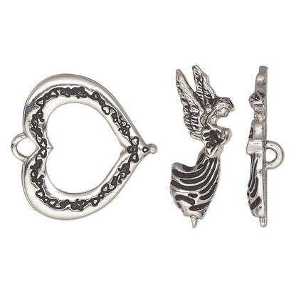 Silver-toned jewelry findings set featuring a heart-shaped clasp with an engraved chain pattern, a winged angel charm, and a side profile of the clasp on a white background.