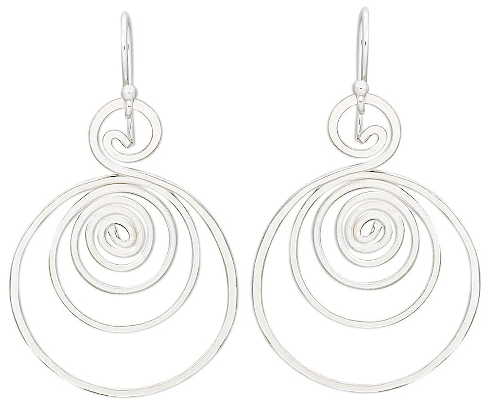A pair of silver drop earrings with a unique spiral design, featuring concentric open circular spirals hanging from simple silver fishhook wires, shown against a plain white background.