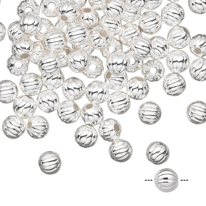 Silver beads with striped pattern on a white background