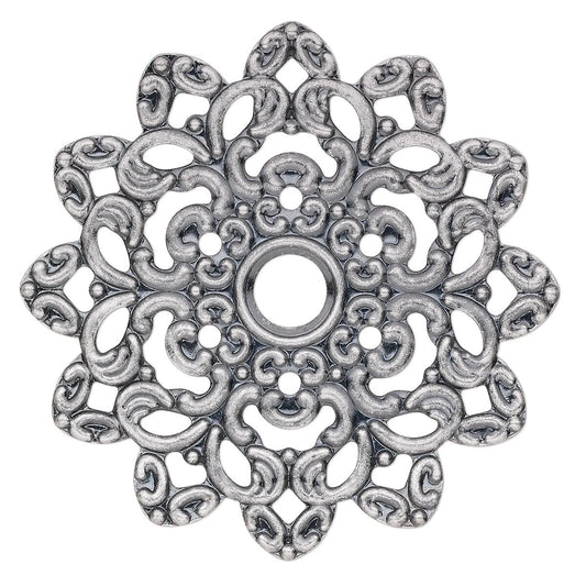 An ornate silver-toned metal filigree charm with a circular center hole and intricate scrollwork, shown on a plain white background.
