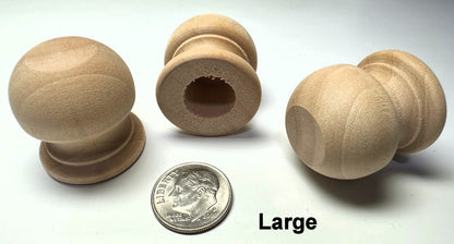 Set of large wooden knobs with a coin for scale on a white background