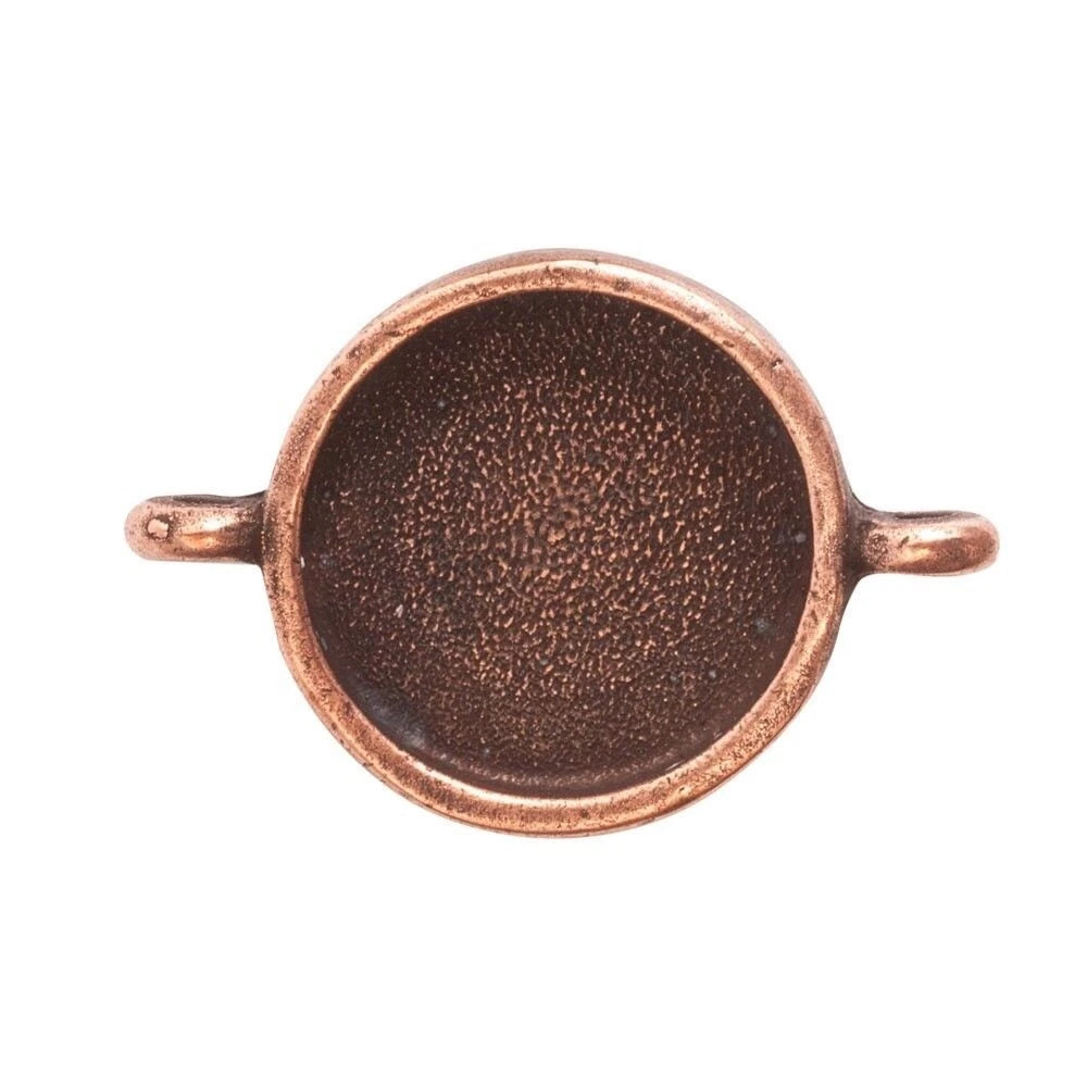 A copper-colored metal ring blank with a textured center and two small side loops, shown against a plain white background.