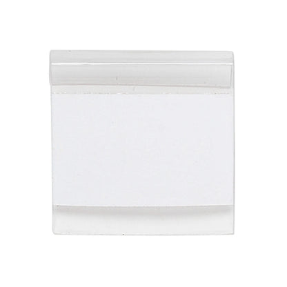A blank white rectangular card or label with a clear plastic cover on a solid white background.
