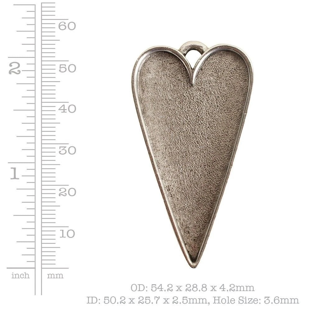 A heart-shaped silver metal pendant with a textured finish and a top loop, shown next to a ruler for scale with dimensions printed below.