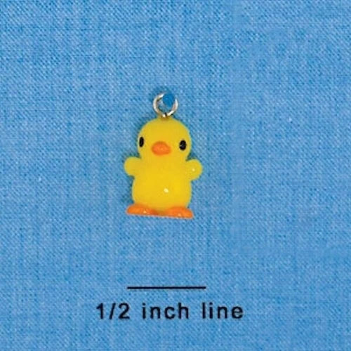 A small yellow duck charm with an orange beak and feet, shown on a blue textured background with a size marker reading '1/2 inch line' underneath.
